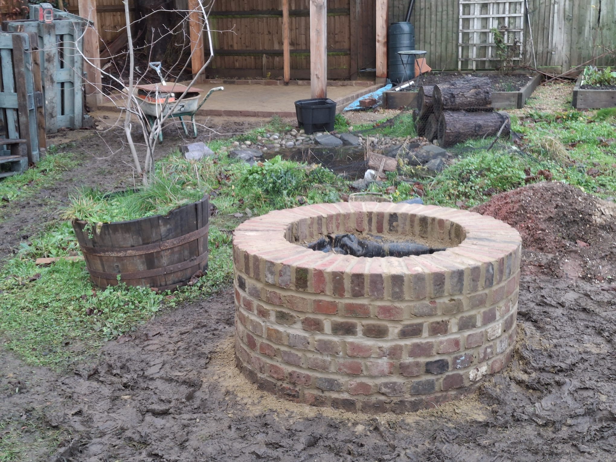 Circular brick fire pit — bespoke garden feature